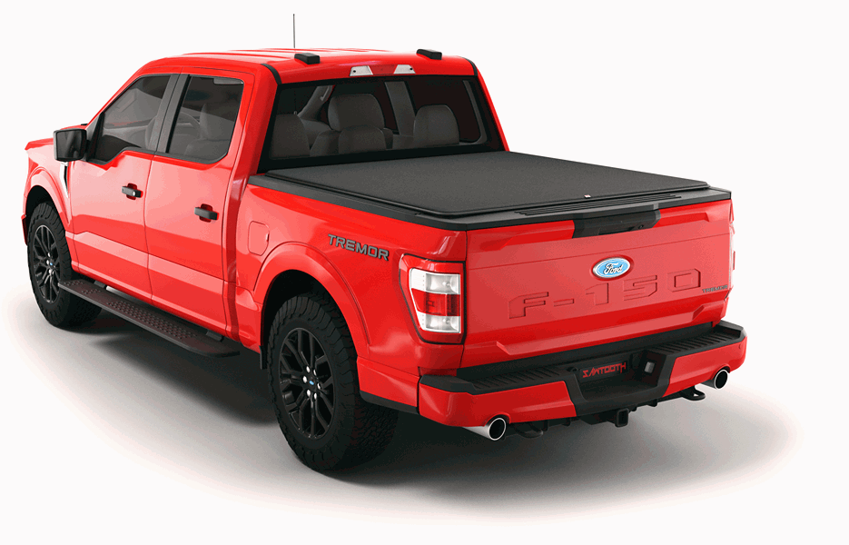 Red f-150 pickup truck with black hard tonneau cover viewed from the rear three-quarter angle