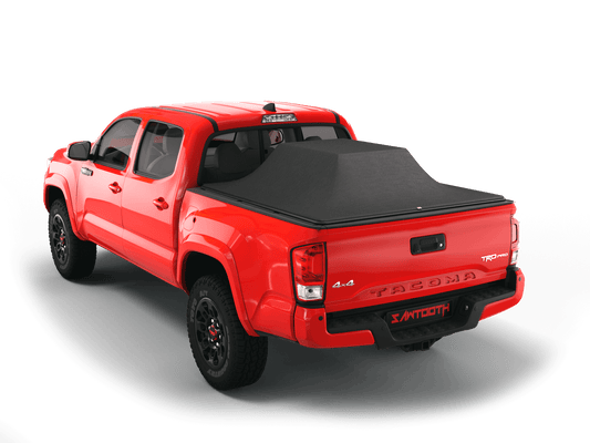 Red Toyota Tacoma with loaded and expanded Sawtooth Stretch pickup truck bed cover