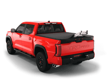 Load image into Gallery viewer, Red 2022 Toyota Tundra 5&#39; 6&quot; Bed with ladder sticking out of Sawtooth Stretch expandable truck bed cover
