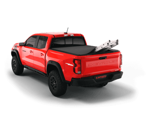 Red 2023 Chevrolet Colorado 5' 2" Bed / GMC Canyon 5' 2" Bed with ladder sticking out of Sawtooth Stretch expandable truck bed cover