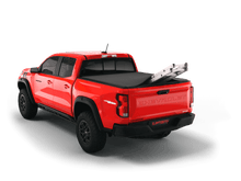 Load image into Gallery viewer, Red 2023 Chevrolet Colorado 6&#39; 2&quot; Bed / GMC Canyon 6&#39; 2&quot; Bed with ladder sticking out of Sawtooth Stretch expandable truck bed cover
