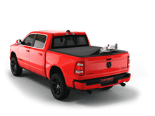 Load image into Gallery viewer, Red 2022 Ram 1500 6&#39; 4&quot; Bed with ladder sticking out of Sawtooth Stretch expandable truck bed cover
