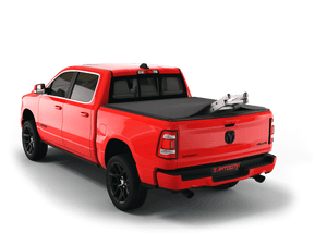 Red 2022 Ram 1500 6' 4" Bed with ladder sticking out of Sawtooth Stretch expandable truck bed cover