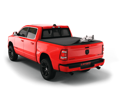 Red Ram 3500 with ladder sticking out of Sawtooth Stretch expandable truck bed cover
