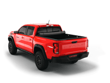 Load image into Gallery viewer, Red 2025 Chevrolet Colorado 5&#39; 2&quot; Bed / GMC Canyon 5&#39; 2&quot; Bed with Sawtooth Stretch expandable soft roll up tonneau cover rolled up. 
