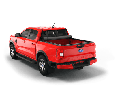 A red Ford Ranger pickup truck with a rolled up Sawtooth STRETCH truck bed cover shown from a rear three-quarter angle on a clean white background.