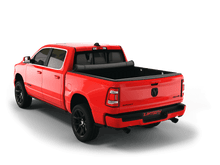 Load image into Gallery viewer, Red 2023 Ram 1500 6&#39; 4&quot; Bed with Sawtooth Stretch expandable tonneau cover rolled up at cab
