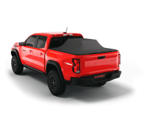 Load image into Gallery viewer, Red 2024 Chevrolet Colorado 5&#39; 2&quot; Bed / GMC Canyon 5&#39; 2&quot; Bed with gear in the truck bed and the Sawtooth Stretch tonneau cover expanded over cargo load
