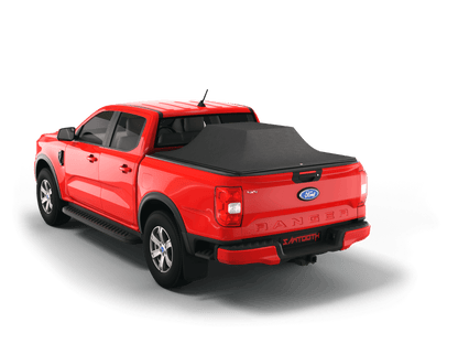 A red Ford Ranger pickup truck shown from a rear three-quarter angle with a Sawtooth STRETCH truck bed cover stretched over tall cargo on a clean white background, fitted with a black tonneau-style bed cover.