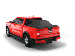 Red 2024 Ford Ranger 5' Bed with gear in the truck bed and the Sawtooth Stretch tonneau cover expanded over cargo load