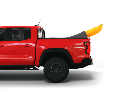 Red Chevrolet Colorado / GMC Canyon with yellow kayak under sawtooth stretch truck bed cover