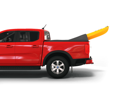 A red pickup truck shown in side profile on a white studio background, with a bright yellow kayak resting in the bed under a black Sawtooth STRETCH truck bed cover.