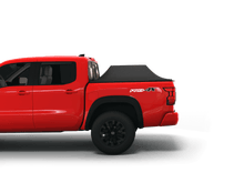 Load image into Gallery viewer, Red 2023 Nissan Frontier 6&#39; Bed with Sawtooth Stretch tonneau cover expanded over cargo load
