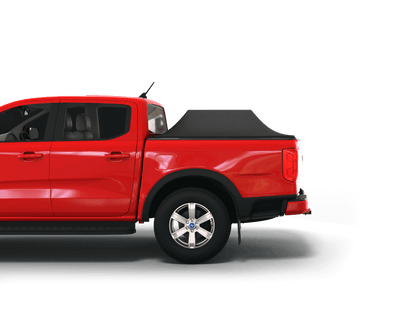 A red pickup truck shown in side profile on a clean white studio background, with an expanded Sawtooth STRETCH truck bed cover black soft-sided bed cover fitted over the truck bed.