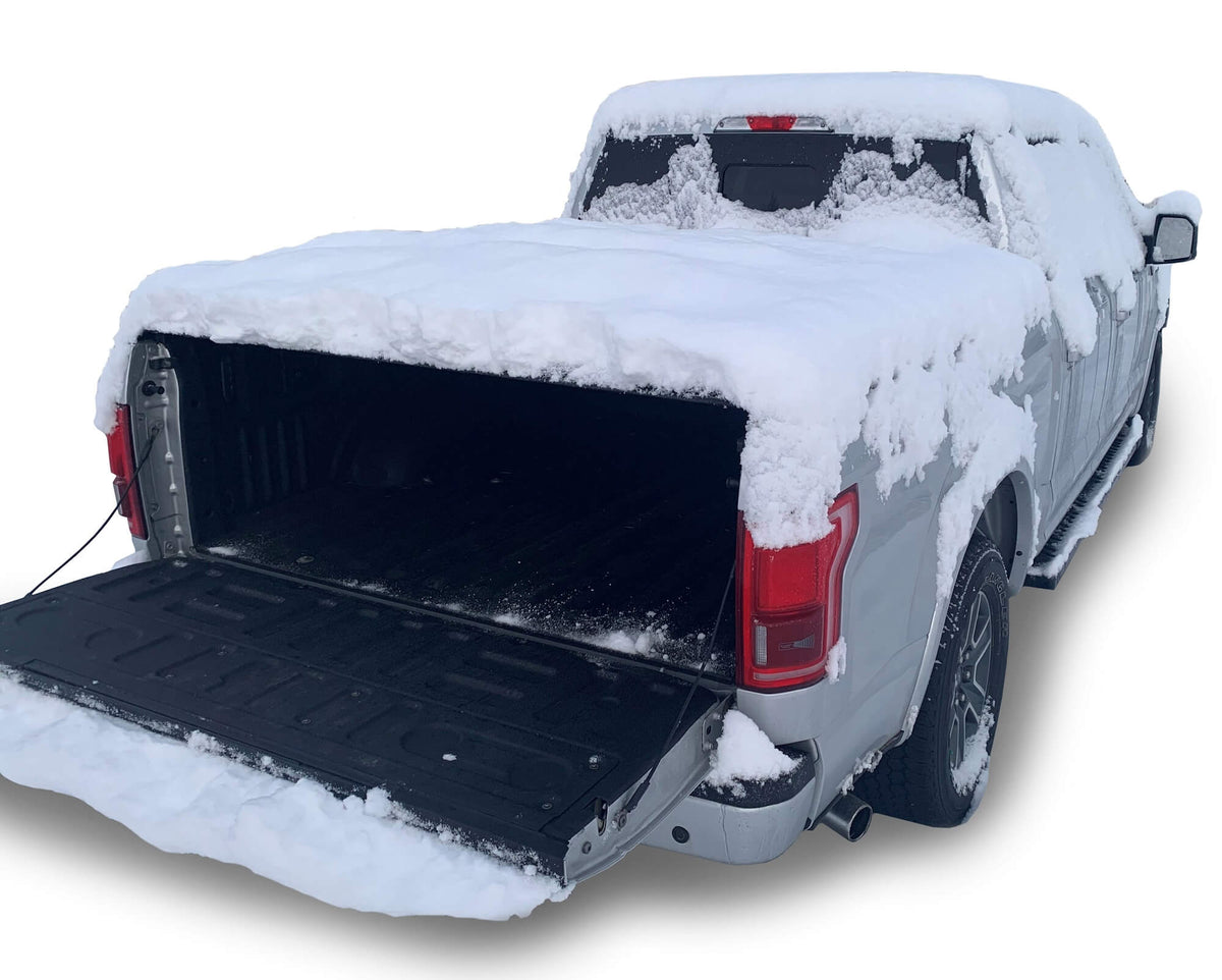 Snow-covered pickup truck with an open bed on a white background