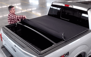 Rolling up Sawtooth Stretch expandable tonneau cover on a 2023 Nissan Frontier 6' Bed