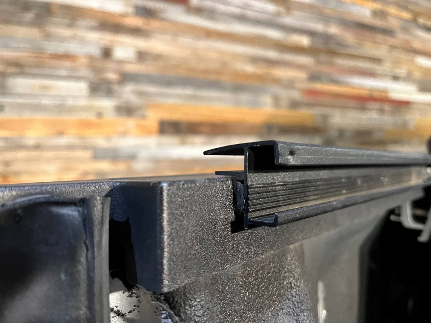 Sawtooth Stretch tonneau black aluminum side rails installed on Ram 3500 pickup truck bed rails