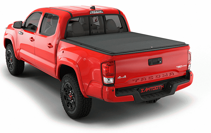 Red Toyota Tacoma pickup truck with black tonneau bed cover, rear three-quarter view