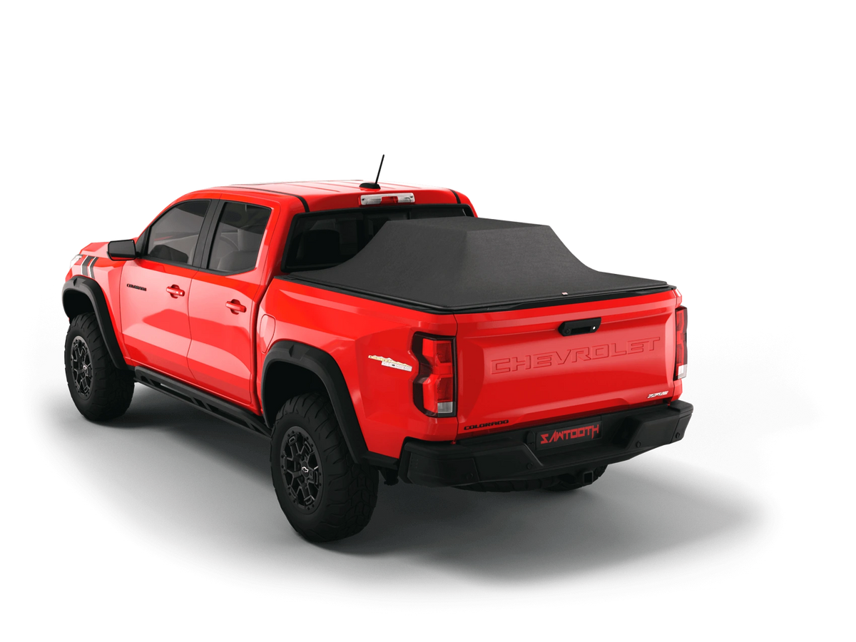 Red Chevrolet Colorado with the Sawtooth STRETCH cover raised over cargo above the bed rails