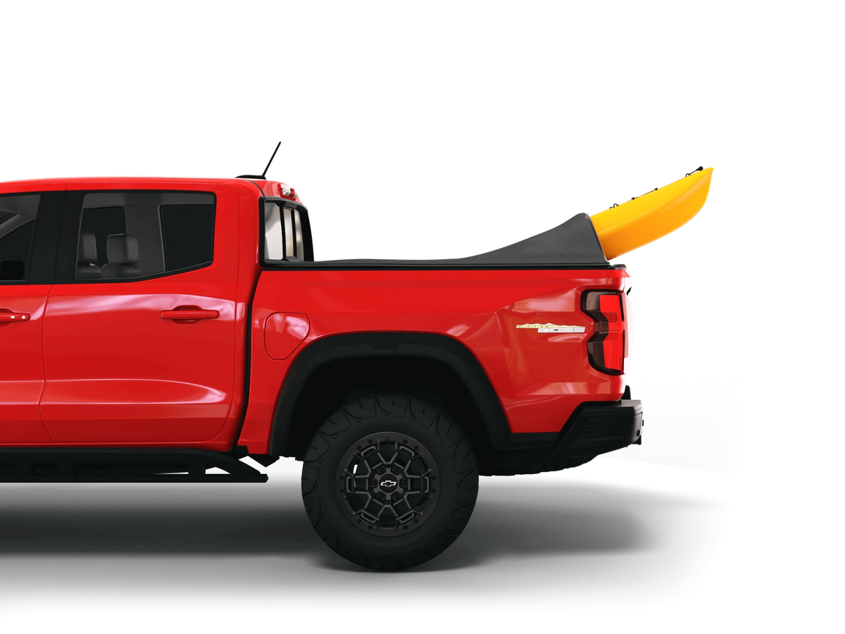 Sawtooth STRETCH adapting around a yellow kayak extending above a red truck bed