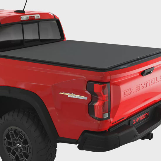 Sawtooth STRETCH A.C.M.S. video showing how the expandable tonneau works on a red pickup truck with a white background.