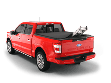Load image into Gallery viewer, Red 2018 Ford F-150 5&#39; 7&quot; Bed with ladder sticking out of Sawtooth Stretch expandable truck bed cover

