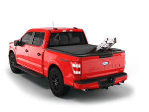 Red 2024 Ford F-150 6' 7" Bed with ladder sticking out of Sawtooth Stretch expandable truck bed cover