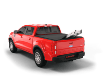 Load image into Gallery viewer, Red 2022 Ford Ranger with ladder sticking out of Sawtooth Stretch expandable truck bed cover

