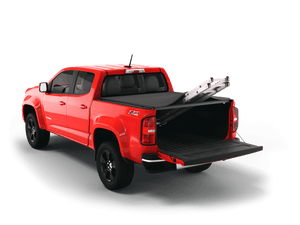 Red 2019 Chevrolet Colorado 5' 2" Bed / GMC Canyon 5' 2" Bed with Sawtooth Stretch expandable tonneau cover rolled up at cab