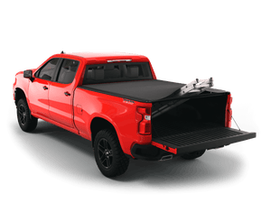 Red 2024 Chevrolet Silverado 2500 3500 6'-9" bed / GMC Sierra 2500 3500 6'-9" bed with Sawtooth Stretch expandable tonneau cover rolled up at cab