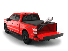 Load image into Gallery viewer, Red 2022 Ford F-150 6&#39; 7&quot; Bed with Sawtooth Stretch expandable soft roll up tonneau cover with ladder and open tailgate 
