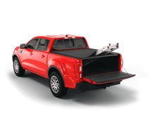 Load image into Gallery viewer, Red 2023 Ford Ranger with Sawtooth Stretch expandable tonneau cover rolled up at cab
