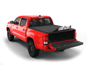 Red 2014 Toyota Tacoma 5' Bed with Sawtooth Stretch expandable tonneau cover rolled up at cab