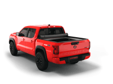 Load image into Gallery viewer, Red 2023 Nissan Frontier 5&#39; Bed with Sawtooth Stretch expandable tonneau cover rolled up at cab
