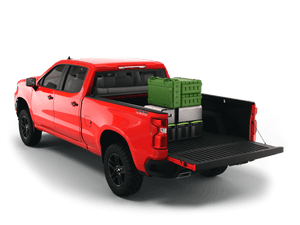 Red 2021 Chevrolet Silverado 2500 3500 6'-9" bed / GMC Sierra 2500 3500 6'-9" bed with gear in the truck bed and the Sawtooth Stretch tonneau cover rolled up at cab 