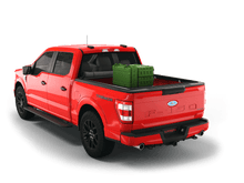 Load image into Gallery viewer, Red 2023 Ford F-150 5&#39; 7&quot; Bed with gear in the truck bed and the Sawtooth Stretch tonneau cover rolled up at cab 
