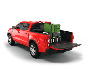 Red 2019 Ford Ranger with gear in the truck bed and the Sawtooth Stretch tonneau cover rolled up at cab 