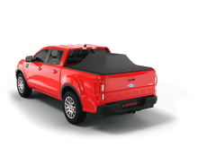 Load image into Gallery viewer, Red 2020 Ford Ranger with gear in the truck bed and the Sawtooth Stretch tonneau cover expanded over cargo load
