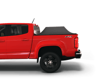 Load image into Gallery viewer, Red 2017 Chevrolet Colorado 5&#39; 2&quot; Bed / GMC Canyon 5&#39; 2&quot; Bed with Sawtooth Stretch tonneau cover expanded over cargo load
