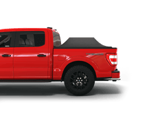 Load image into Gallery viewer, Red 2023 Ford F-150 5&#39; 7&quot; Bed with Sawtooth Stretch tonneau cover expanded over cargo load
