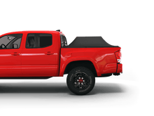 Load image into Gallery viewer, Red 2019 Toyota Tacoma 6&#39; Bed with Sawtooth Stretch tonneau cover expanded over cargo load
