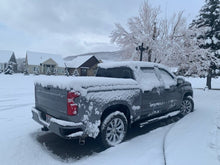 Load image into Gallery viewer, Red 2024 Chevrolet Silverado 2500 3500 6&#39;-9&quot; bed / GMC Sierra 2500 3500 6&#39;-9&quot; bed with snow covering a flat Sawtooth Tonneau
